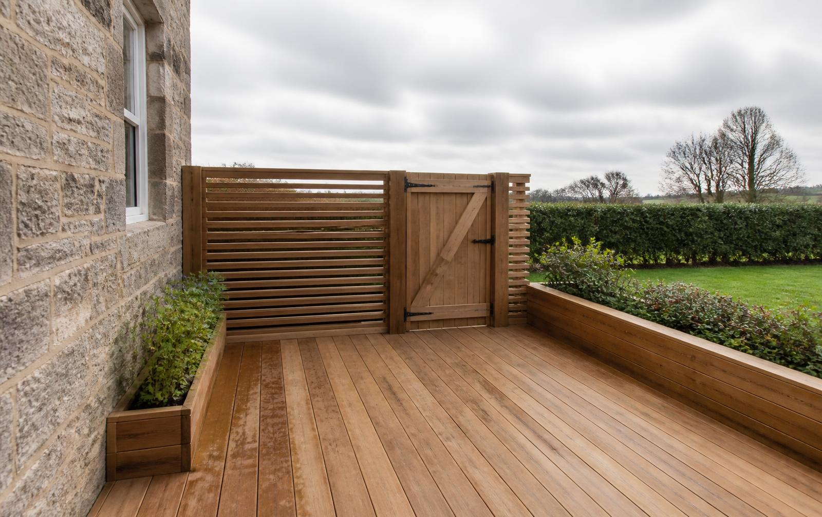 Hardwood decking with a slatted timber screen and gate at a granite house near Mintlaw